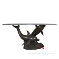 bronze table base with dolphin statues